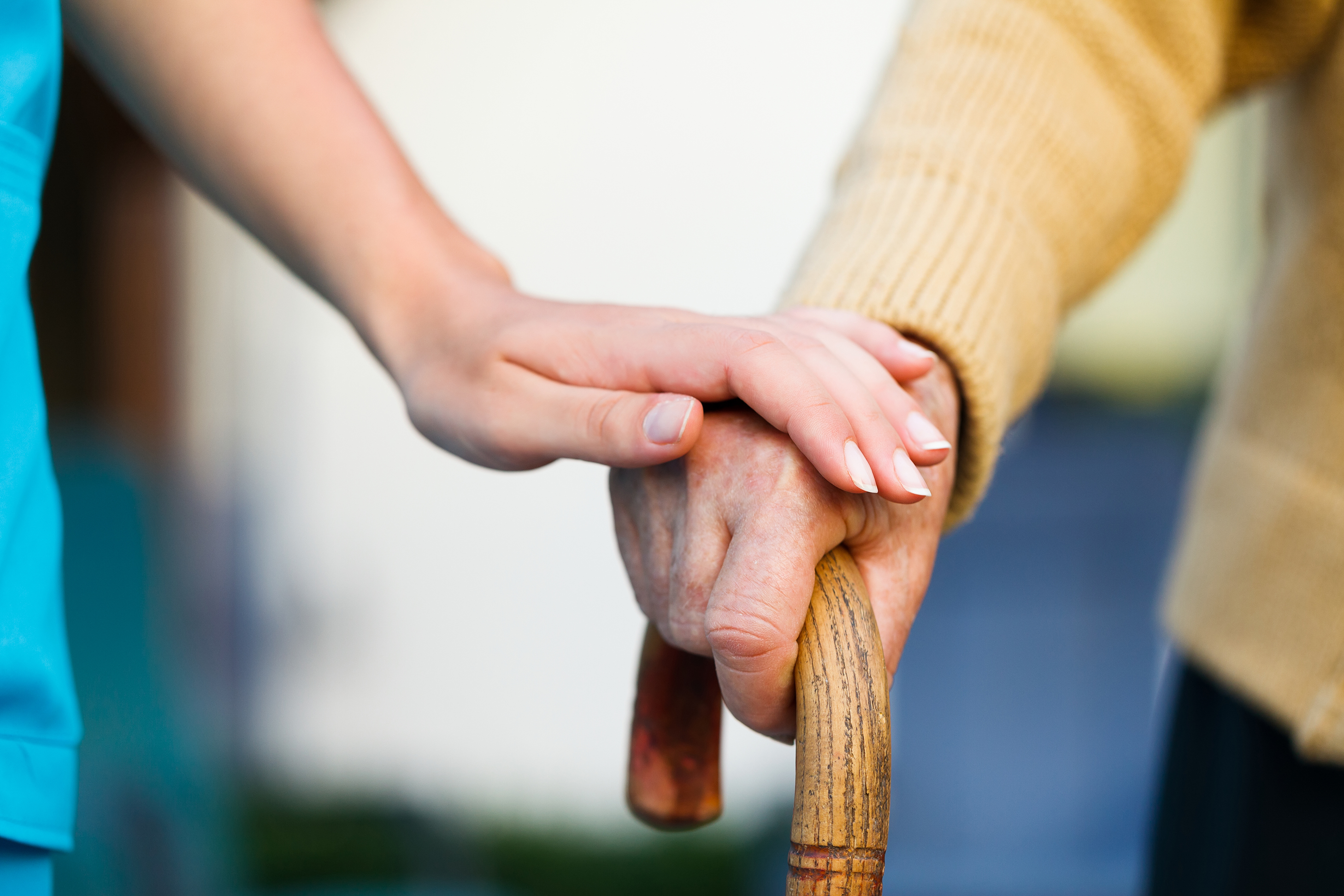 Picture of Supportive Caregiver Hands & Elderly Hands on Cane