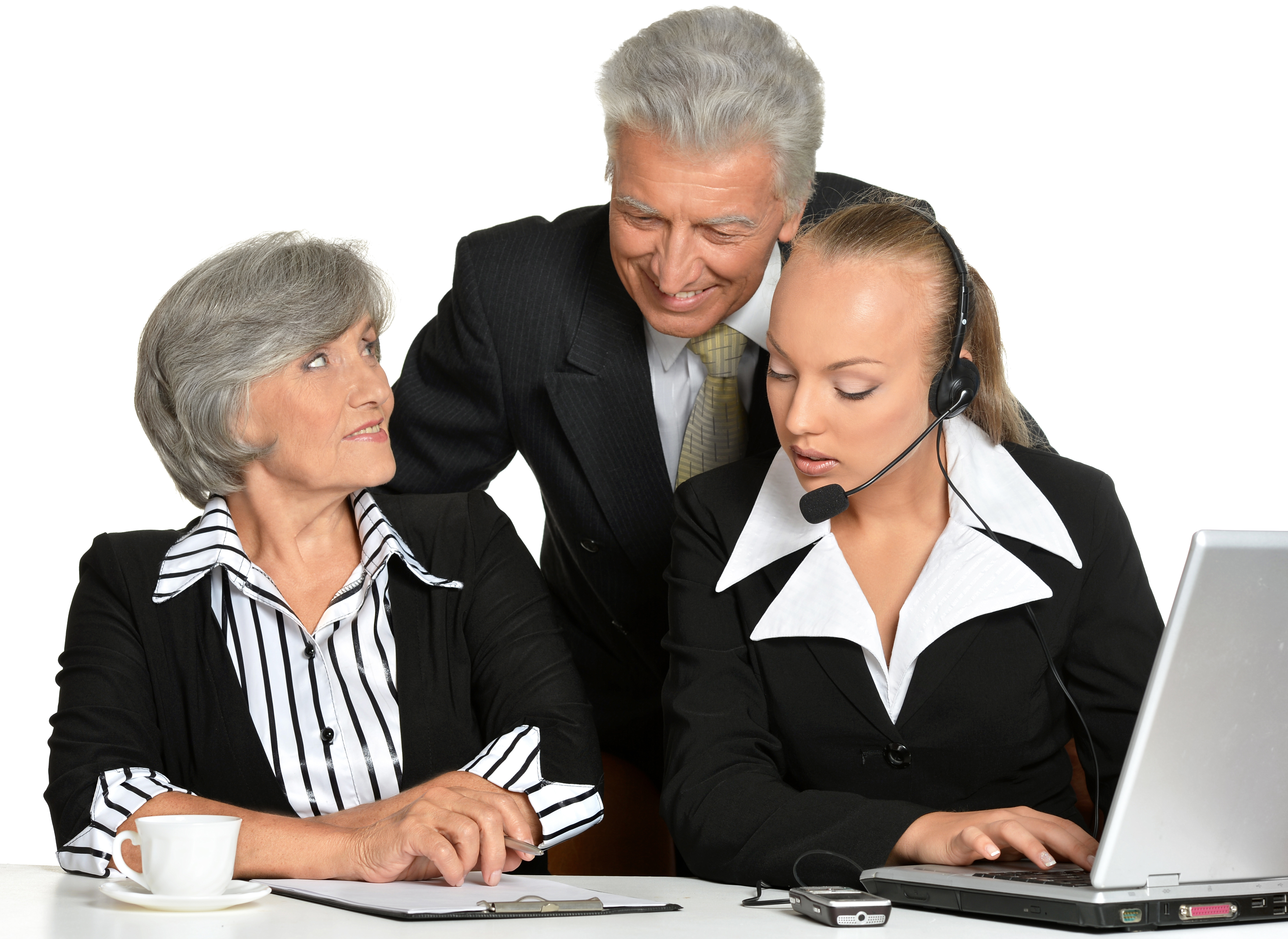 Image of three professionally dressed people working together at a computer helping each other
